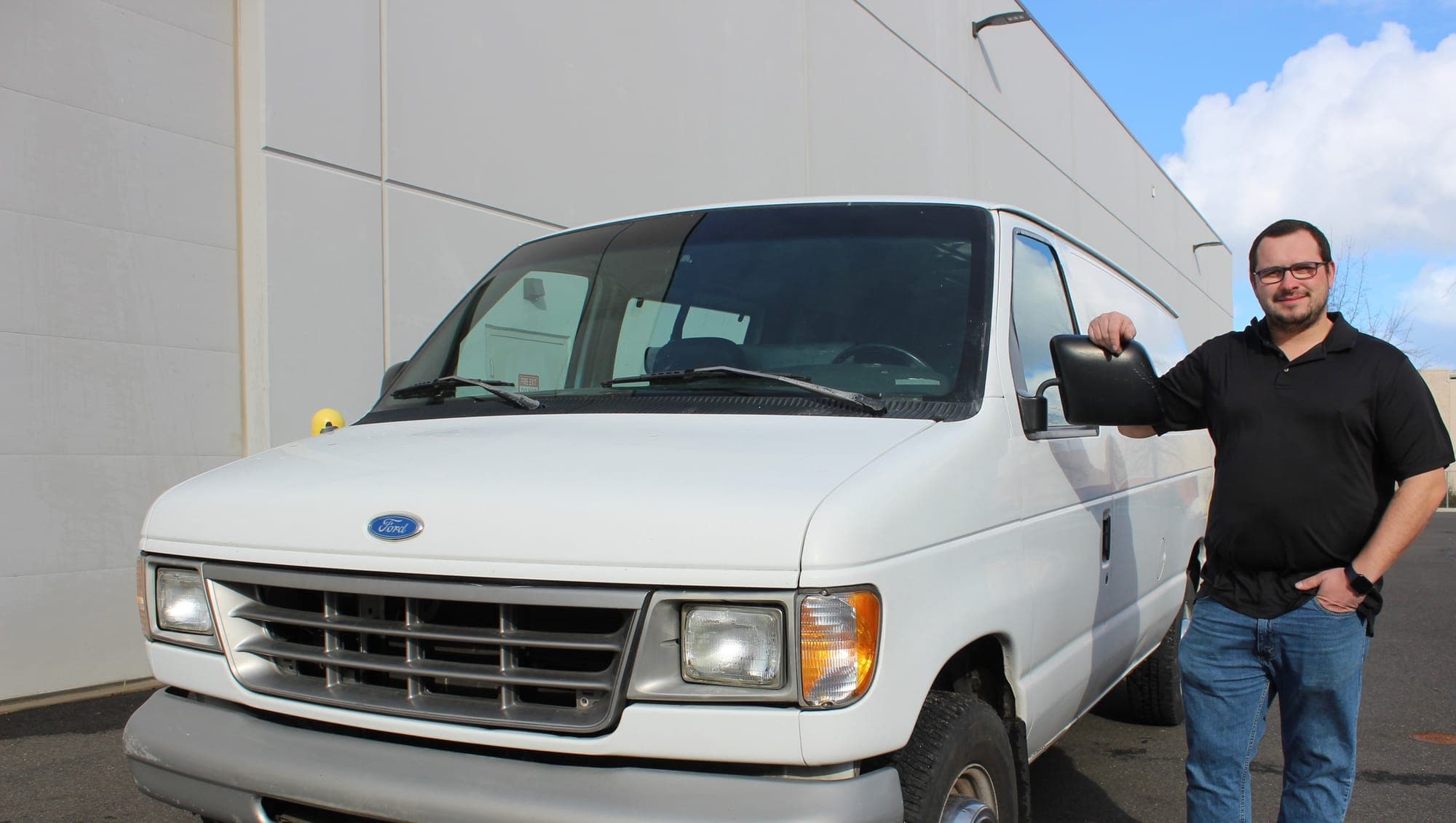 An Empire Cleaning team member with the company van before a Post Falls carpet cleaning job